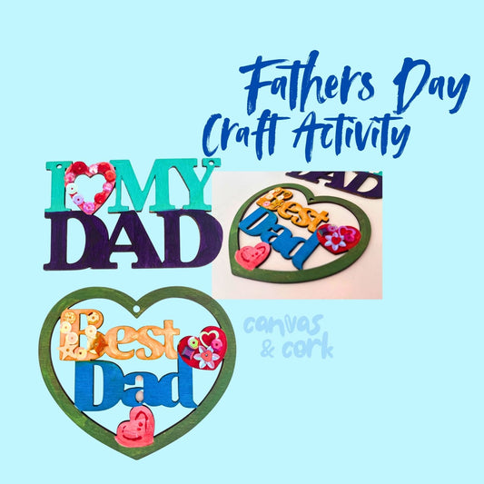 A promotional graphic for a 'Fathers Day Craft Activity' featuring sample DIY craft pieces made from canvas and cork. The designs include 'I [heart] MY DAD' with a floral heart, a 'Best Dad' sign, and a heart-shaped 'Best Dad' canvas and cork art piece, all set against a light blue background with blue text.
