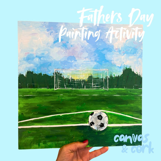 A hand holds a square canvas painting of a soccer field with a goal, trees, sky, and a soccer ball. Large white text at the top reads 'Fathers Day Painting Activity,' and 'canvas & cork' appears in the lower right.